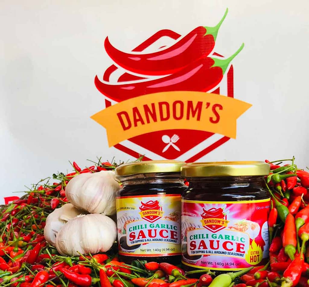 Dandom's Chili Garlic Sauce with Dandoms Logo on the background